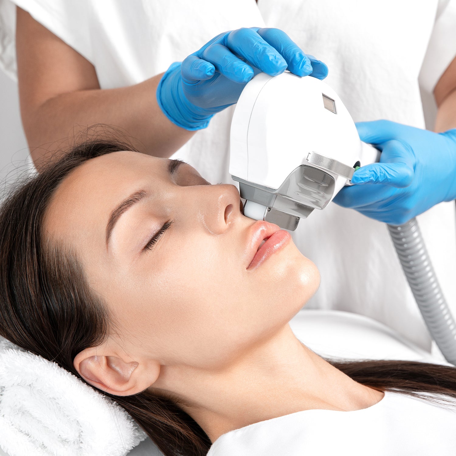 A woman getting a laser treatment done on her face.