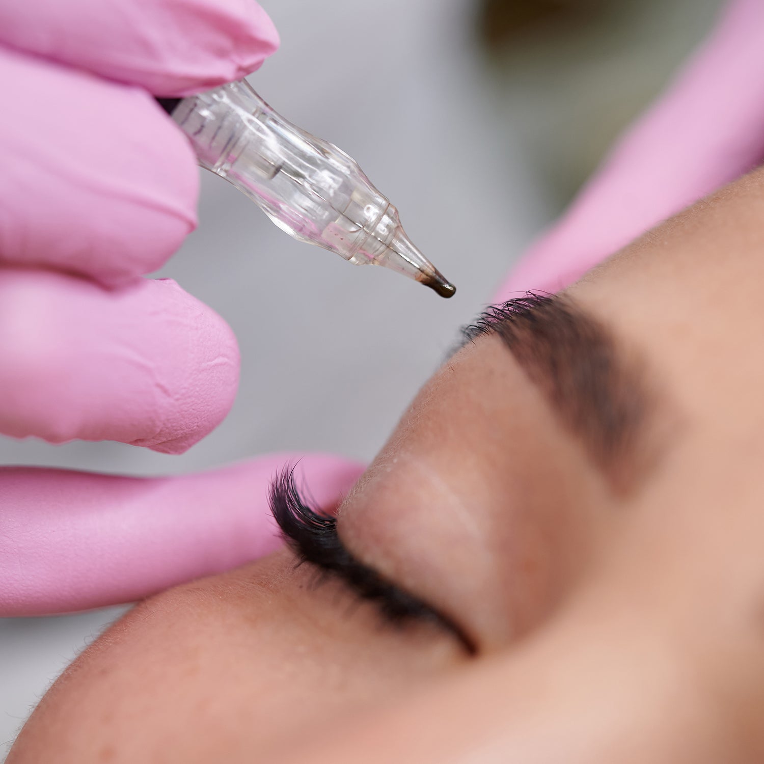 Close up of woman receiving eyebrow permanent makeup.